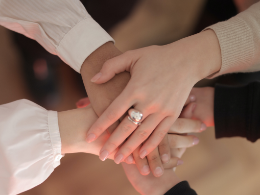 Four hands of youth stacked on top of each other